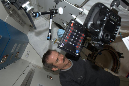 Photo of Chris Hadfield mixing colloids