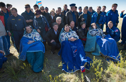 The Expedition 34/35 crew resting in chairs