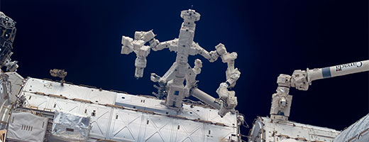 Dextre, with arms open, anchored to the American laboratory, Destiny, on the International Space Station