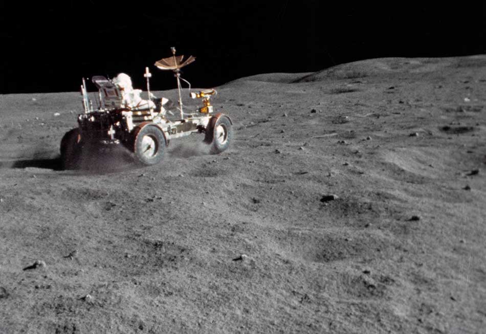 astronaut drives on the Moon in a rover