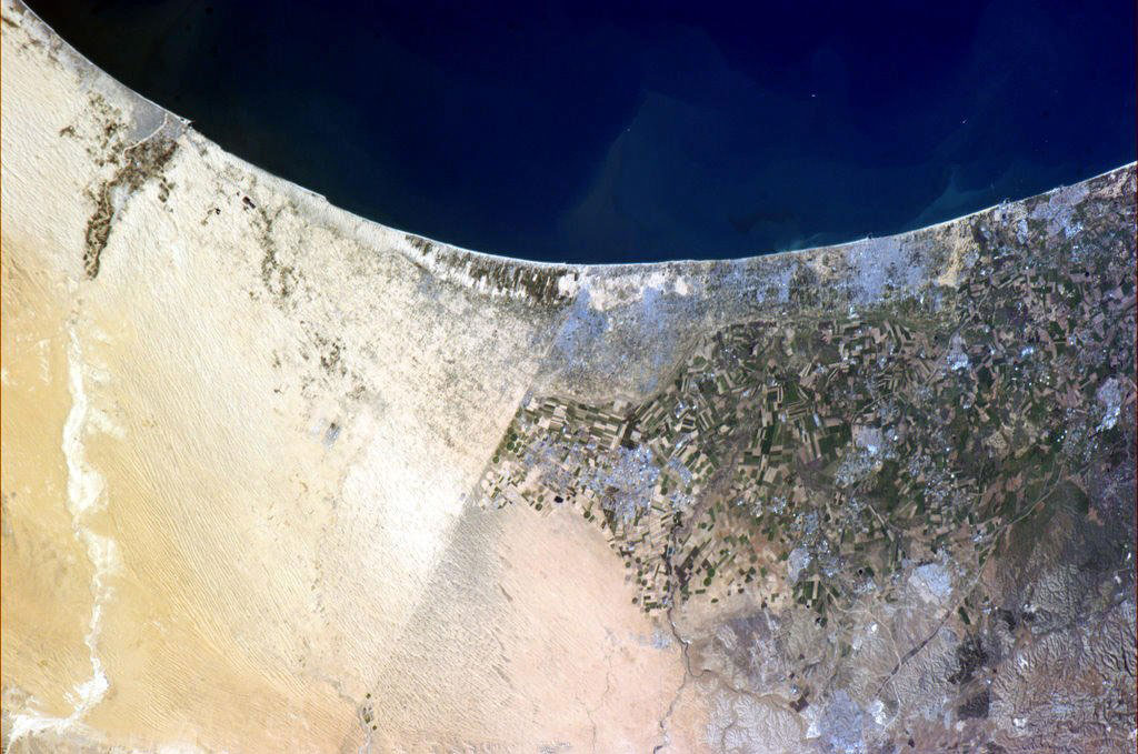 In this photo taken from the International Space Station by former Canadian astronaut Chris Hadfield, a clearly visible line (a road) marks the border between Egypt and Israel. Fields are seen in Israel while the lighter color of the Egyptian soil is a result of trampling by livestock, which disrupts the dark soil crusts. (Credit: Chris Hadfield/Canadian Space Agency)