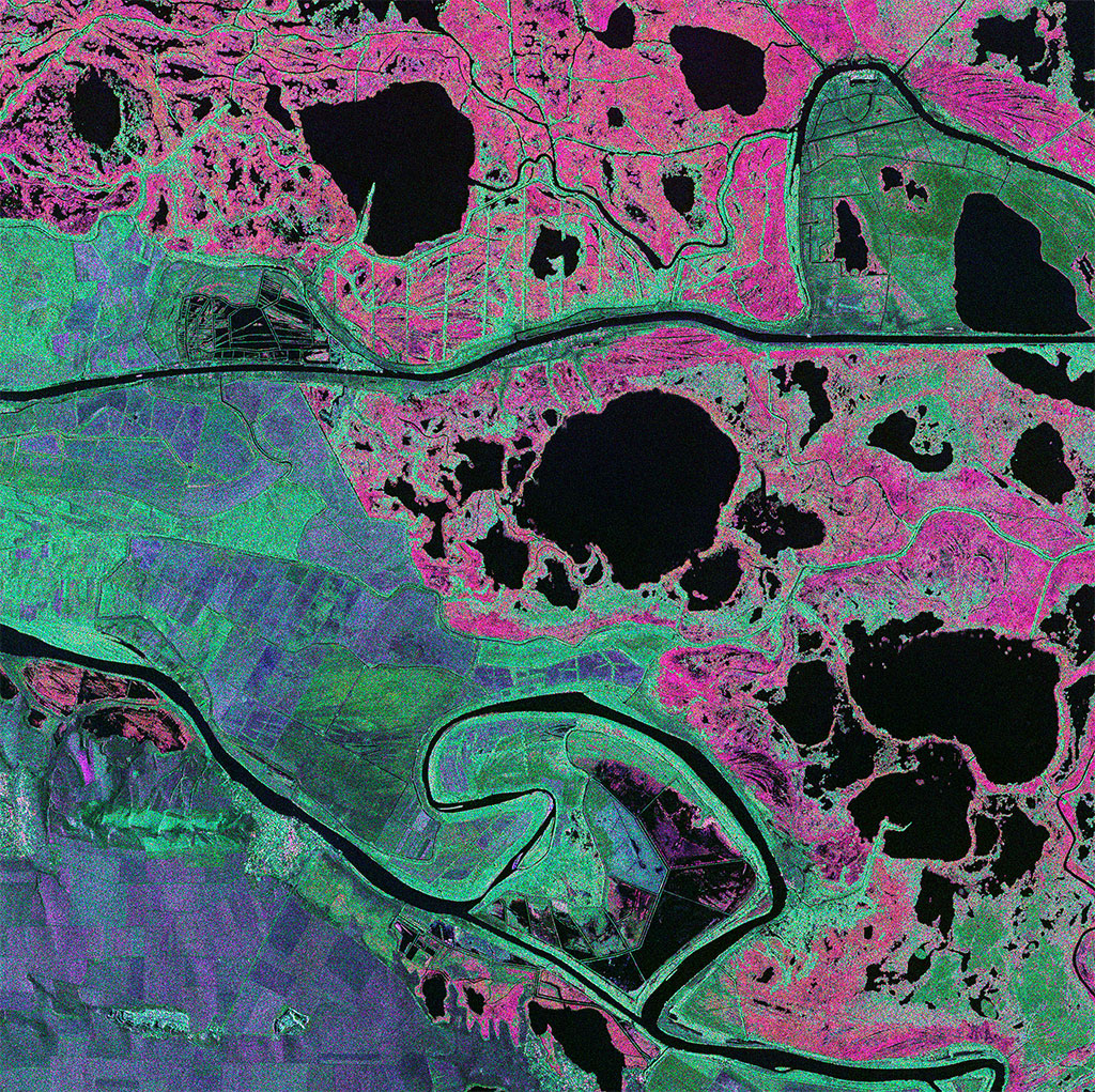 The Danube Delta is the second largest river delta in Europe, situated on the Romanian border with the Ukraine. This composite image from Canada's RADARSAT-2 satellite shows an interesting combination of agriculture and wetlands. A clearly defined, dark canal bisects the image, while high water levels in the marsh land clearly show as pink. Agricultural areas are displayed in variations of green and purple. (Credit: RADARSAT-2 Data and Products © MacDonald, Dettwiler and Associates Ltd. 2013 – All rights reserved. RADARSAT is an official trademark of the Canadian Space Agency)