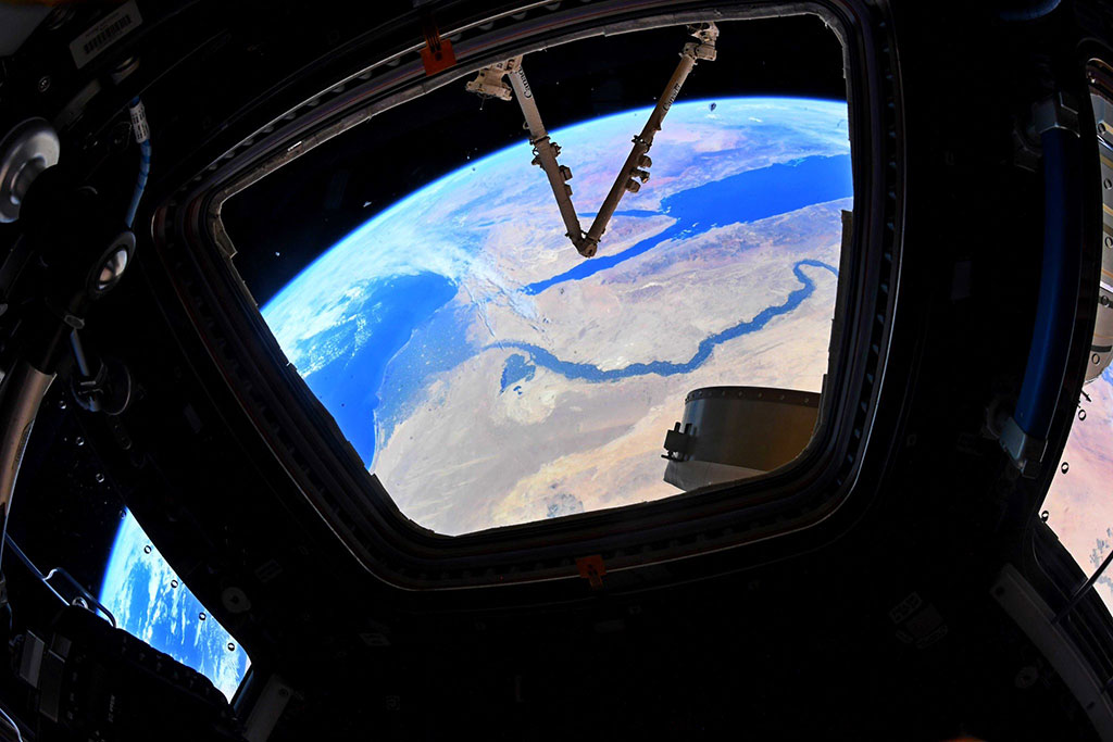Canadarm2 photobombs the Nile River and its delta. They were photographed by David Saint-Jacques through a window of the International Space Station. (Credit: Canadian Space Agency/NASA)