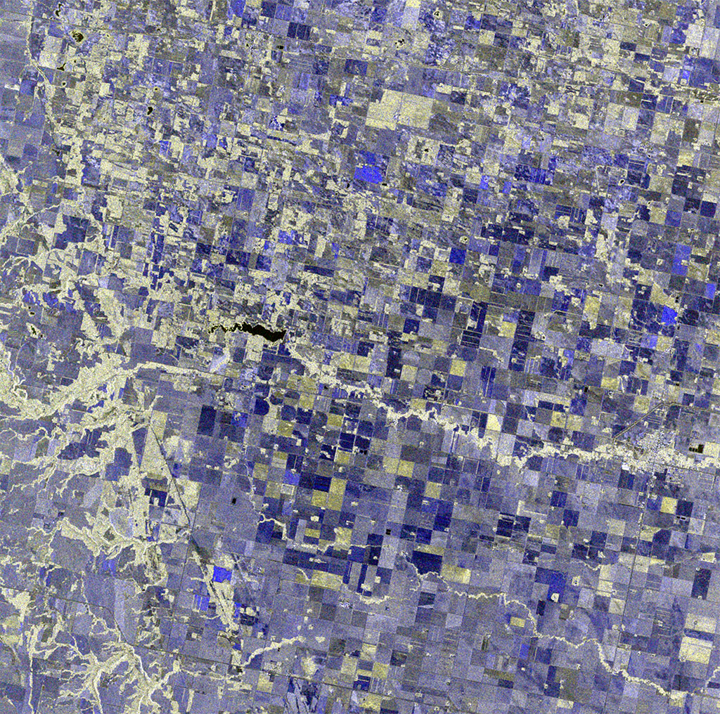 This image of fields was capture by Canada's RADARSAT-2 satellite west of Winnipeg, Manitoba. The darker the blue hue, the less vegetation is on that plot of field and the off white colour that can be seen throughout the image is forested areas. (Credit: RADARSAT-2 Data and Products © MacDonald, Dettwiler and Associates Ltd (2016). All rights reserved. RADARSAT is an official mark of the Canadian Space Agency)