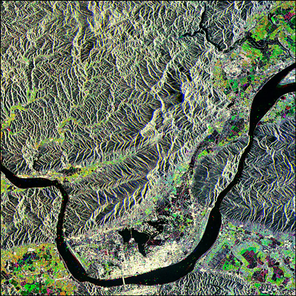 This image of Zhaoqing, China, captured by Canada's RADARSAT-1 satellite, shows different types of vegetation and various crop growth stages. Aquaculture sites and flooded rice paddies appear as very dark and black, while the village areas and banana fields are very light coloured. (Credit: Canadian Space Agency)