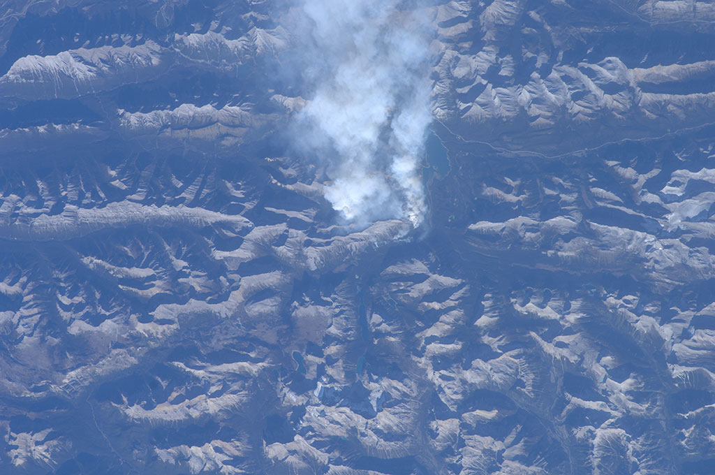 This roiling plume of smoke, a fire set in the mountains near Canmore, Alberta, was taken by Canadian Space Agency Astronaut Bob Thirsk from the International Space Station. Strong winds had pushed the smoke towards areas of Calgary and Cochrane, generating concern among its citizens. Alberta Health Services has issued a precautionary smoke advisory for Bragg Creek, Canmore, Springbank, Cochrane and Calgary. (Credit: NASA)