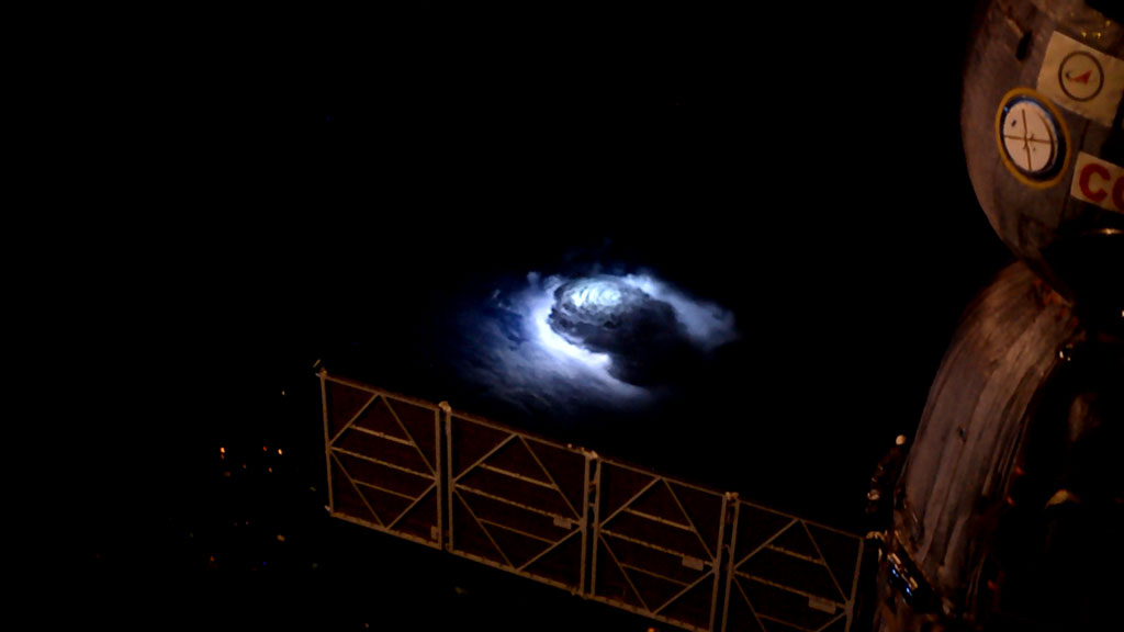 A violent thunderstorm seen from the space station. The Soyuz capsule appears on the right. (Credits: DTU Space/European Space Agency/NASA)
