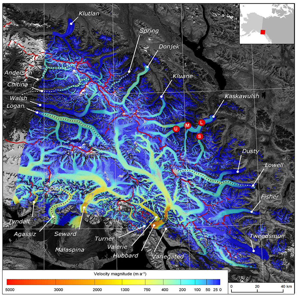 This image shows the velocity of ice movement across the St. Elias Mountains, derived from RADARSAT-2 imagery between February and April 2012. The underlying image was acquired by Landsat 8 in August 2013. Heavy red lines indicate primary ice divides, and a colour scale is used to display the speed of ice movement. The fastest moving areas, indicated in red and yellow, show how the ice is moving like a river network from mountaintops down towards the ocean. (Credit: Waechter et al. (2015), Journal of Glaciology)