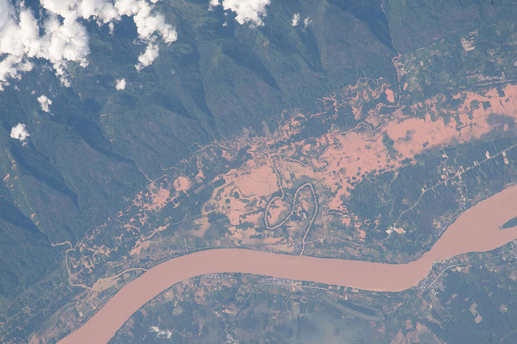 This photo, taken by a crew member aboard the International Space Station, shows not only roads and buildings in great detail, but also evidence of flooding of Southeast Asia's largest river, the Mekong. The Mekong River serves as a trans-boundary river between Thailand and Laos as it spills a reddish-brown channel of floodwater from a heavy monsoon rainfall. (Credit: NASA)