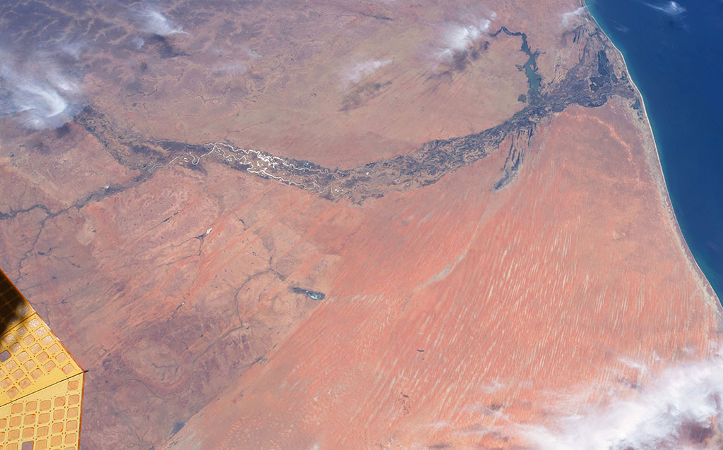 The Senegal River is a 1,086 km long river meandering in West Africa. It forms the border between Senegal and Mauritania. Lake de Guiers, in Senegal, is also seen in this picture captured by David Saint-Jacques from the International Space Station. If you look closely, irrigation systems (circles) and fields (green rectangles) can be seen on the left of the lake. (Credit: Canadian Space Agency/NASA)