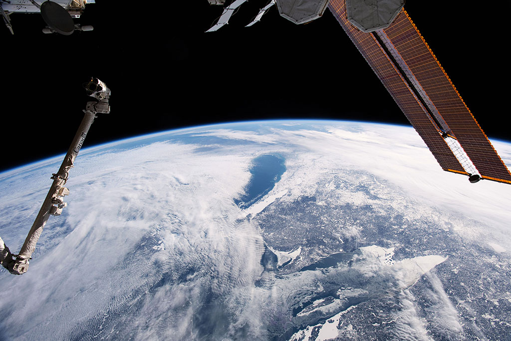 Part of Lake Superior (forefront) and Lake Huron are seen under clouds (and photobombed by Canadarm2!) in this photo of the chilly Great Lakes region. It was taken by David Saint-Jacques from the International Space Station. (Credit: Canadian Space Agency/NASA)
