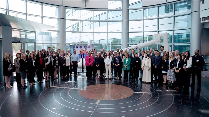 Group photo of the representatives from the signatories of the Artemis Accords in the rotunda of CSA headquarters.