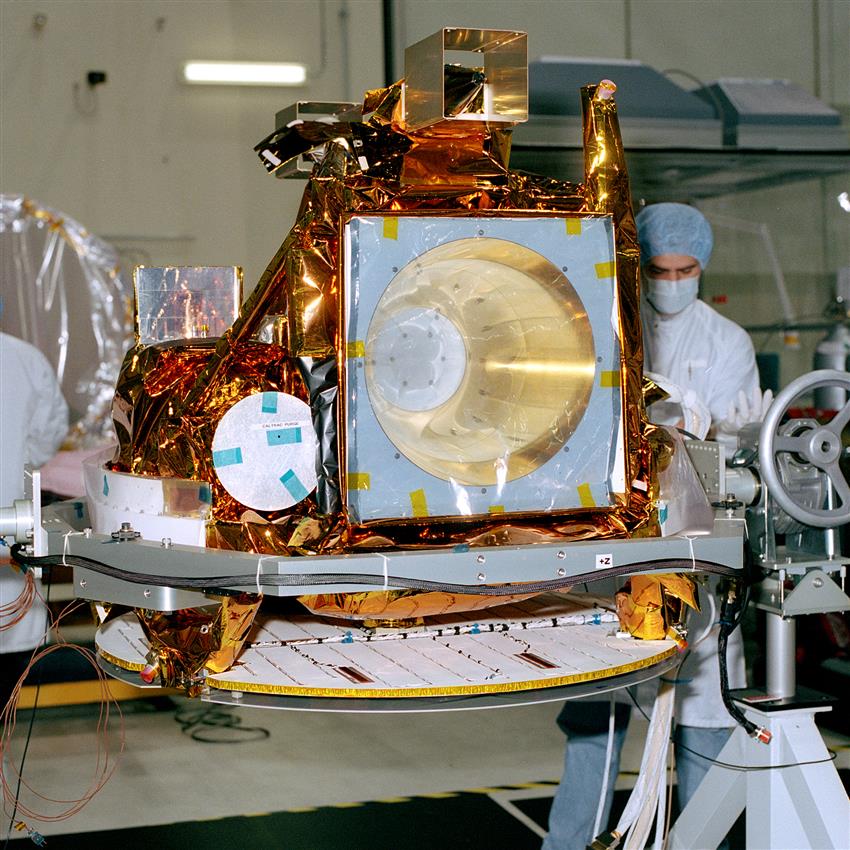 The satellite sits on a table in a laboratory