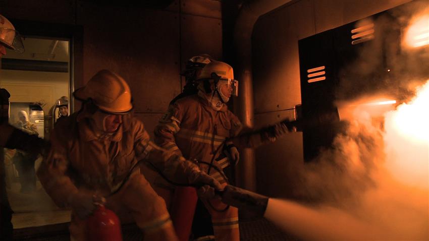 Two astronaut candidates taking part in a fire rescue exercise