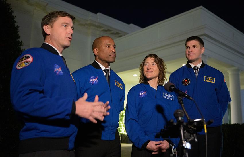 The four astronauts standing near the White House.