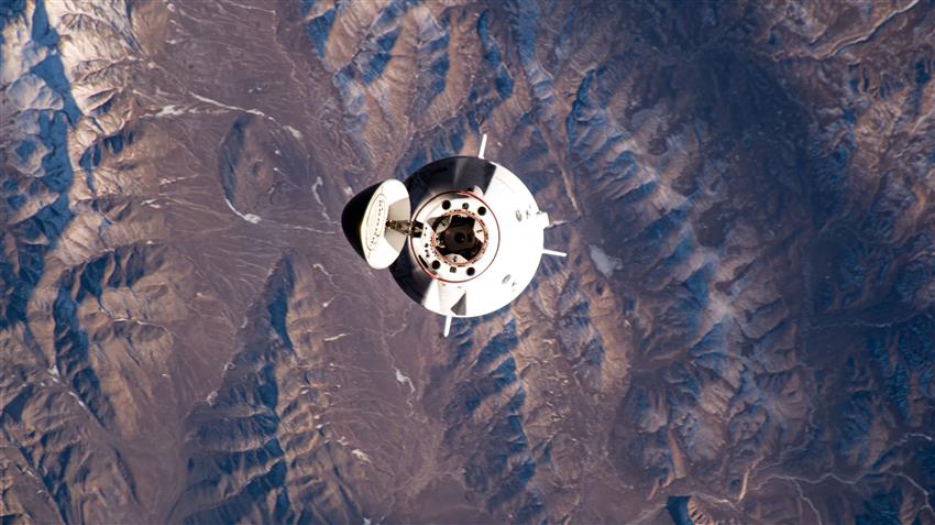 The spacecraft approaches the ISS with its hatch opened.  