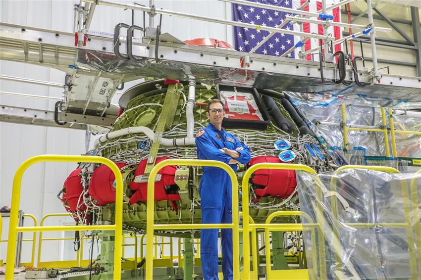 Joshua poses in front of the spacecraft.