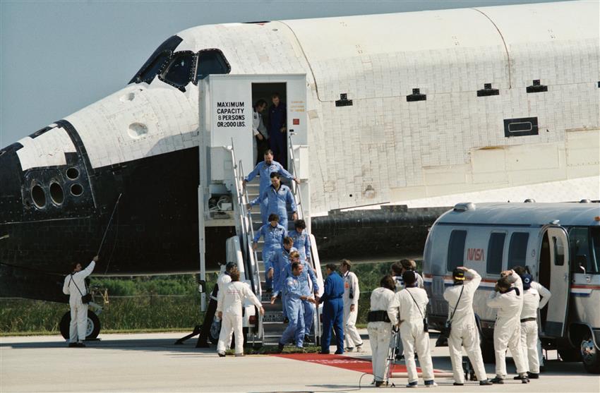 The astronauts leave the space shuttle.