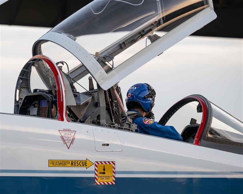Joshua, seen from behind, is wearing his pilot helmet and is sitting in a T-38 jet.