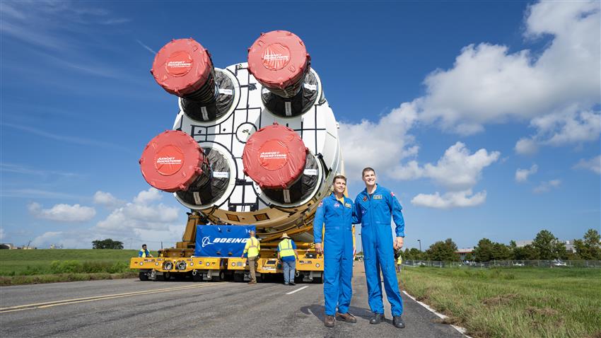 Jeremy and Reid posing in front of the SLS core stage.
