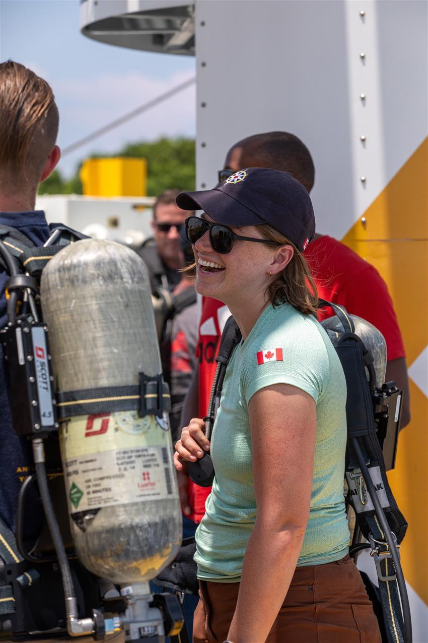 Jenni speaks with a colleague and smiles.