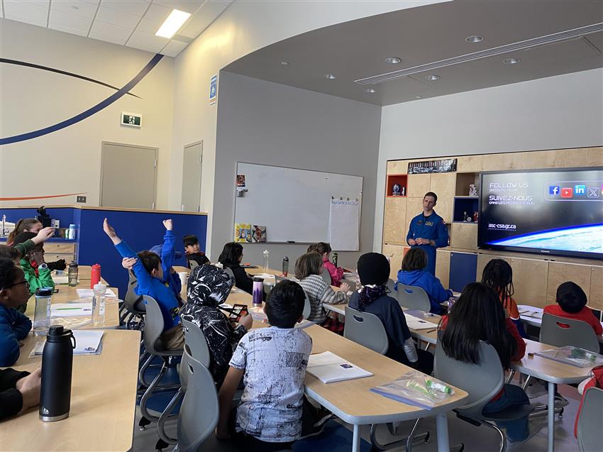 Joshua speaks to students in a classroom.